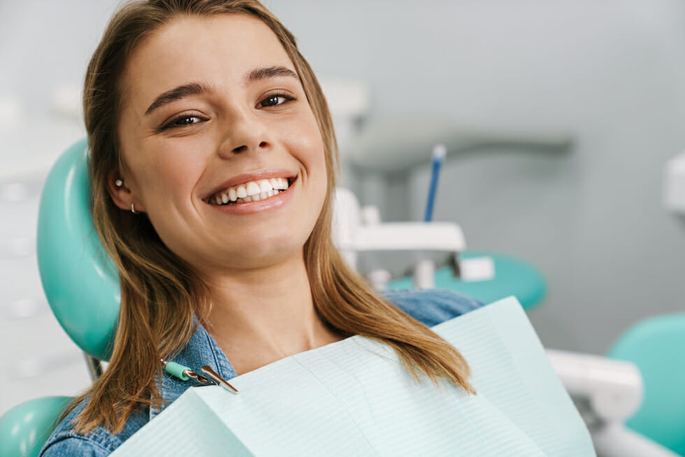 young woman sitting in dentist chair